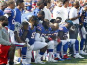 Buffalo Bills players take a knee during the playing of the national anthem prior to an NFL football game against the Denver Broncos, Sunday, Sept. 24, 2017, in Orchard Park, N.Y. (AP Photo/Jeffrey T.