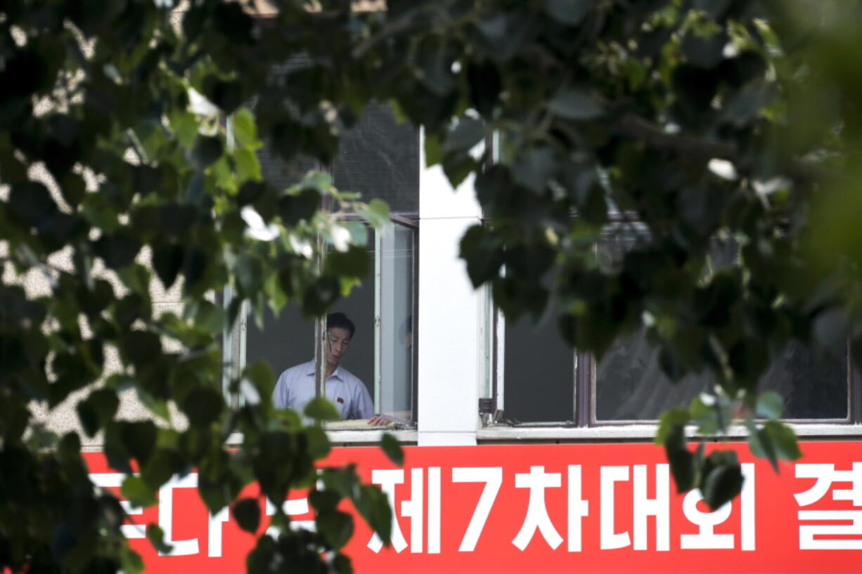 North Korean workers chat at each other near a window of North Korean Embassy in Beijing on Monday. U.S. Defense Secretary Jim Mattis on Sunday shot back at North Korea’s claimed test of a hydrogen bomb with a blunt threat, saying the U.S. will answer any threat from the North with a “massive military response — a response both effective and overwhelming.” Earlier, U.S.