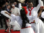 Colombia’s President Juan Manuel Santos talks to Pope Francis during the pontiff’s welcoming ceremony at El Dorado airport in Bogota, Colombia, on Wednesday. Pope Francis has arrived in Colombia for a five-day visit.