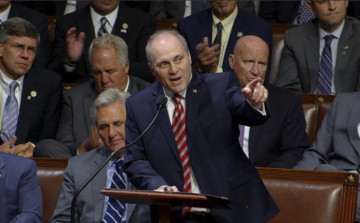 This image from House Television shows House Republican Whip Steve Scalise speaking on the House floor of the Capitol in Washington, Thursday. To hugs and a roaring bipartisan standing ovation, Scalise returned to the House on Thursday, more than three months after a baseball practice shooting left him fighting for his life.