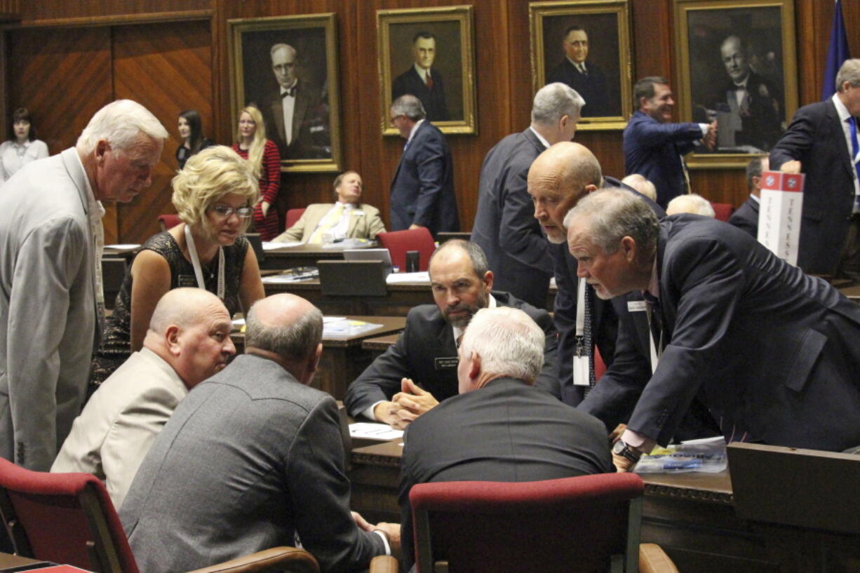 State Rep. Sage Dixon, seated center, huddles with other members of the Idaho Legislature’s delegation to a balanced budget planning convention at the Arizona Capitol in Phoenix on Sept. 12, 2017. Lawmakers from 19 states are trying to develop a plan in Arizona this week for carrying out a growing, but unlikely, national effort to amend the Constitution to require a balanced U.S. budget. The plan is to add an amendment through a convention, a long-shot effort that has never been successfully done.