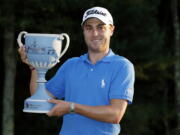 Justin Thomas holds the trophy after winning the Dell Technologies Championship golf tournament at TPC Boston in Norton, Mass., Monday, Sept. 4, 2017.