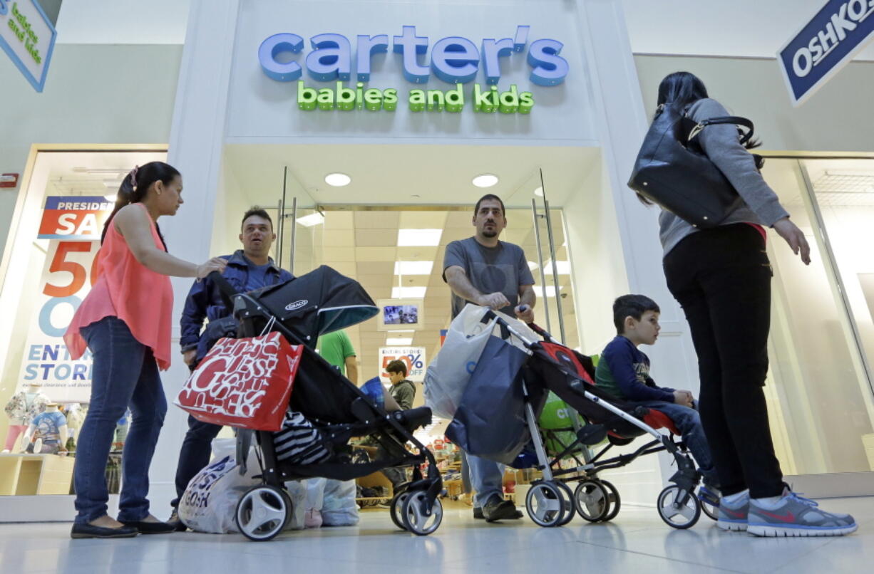 FILE - In this Tuesday, Feb. 9, 2016, file photo, people shop in Miami. After years of sluggish growth, typical U.S. household incomes finally topped pre-recession levels in 2016 and reached an all-time high, according to information released by the Census Bureau, Tuesday, Sept. 12, 2017.