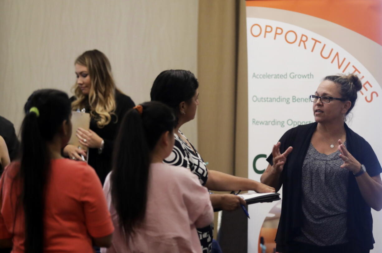 Kathy Tringali, right, a recruiter for retailer Big 5 Sporting Goods, talks to job seekers during a job fair Aug. 24 in San Jose, Calif. U.S. job growth slowed in August as employers added 156,000 jobs, though still enough to suggest that most businesses remain confident in an economy now in its ninth year of recovery from the Great Recession.