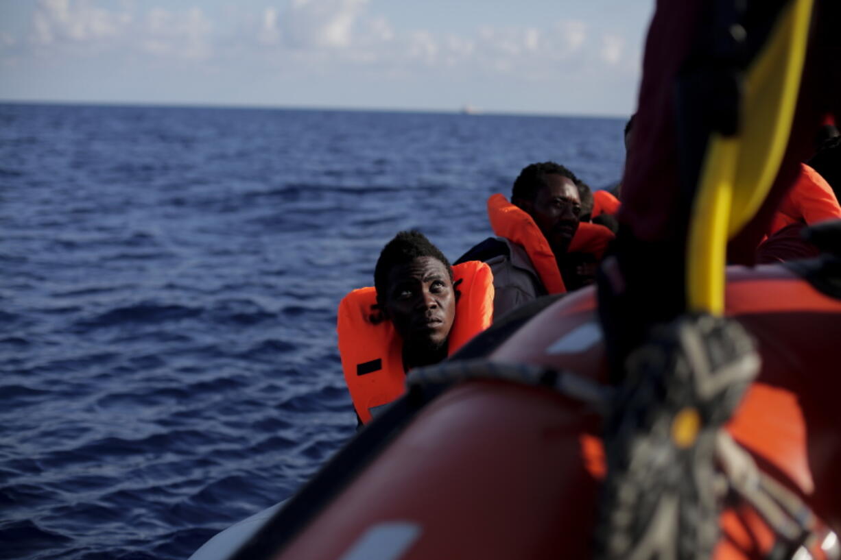 Migrants wait to be rescued from a rubber dinghy by members of the Spanish NGO ProActiva Open Arms during an operation on the Mediterranean Sea, Wednesday, Sept. 6, 2017. ProActiva Open Arms rescued more than 200 migrants Wednesday morning from foundering rubber dinghies about 25 miles north of the Libyan coastal town of al-Khums.