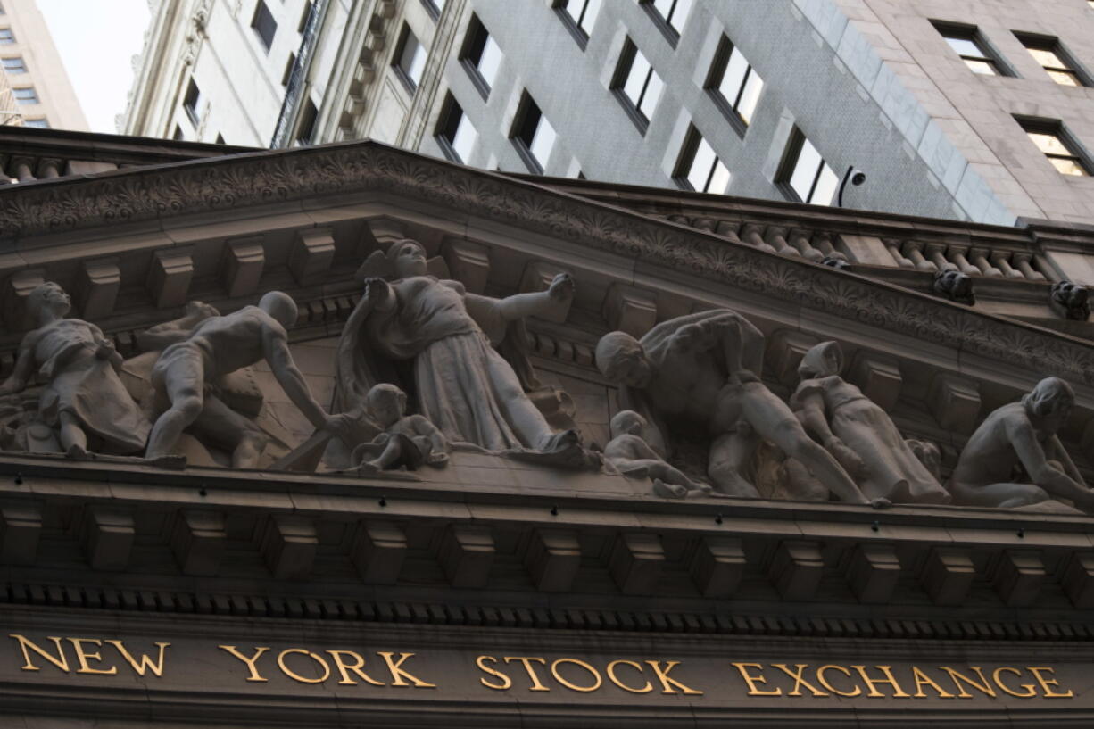 FILE - This Tuesday, Oct. 25, 2016, file photo shows the New York Stock Exchange at sunset, in lower Manhattan. U.S. stock indexes were wavering between tiny gains and losses in early trading Friday, Sept. 8, 2017.