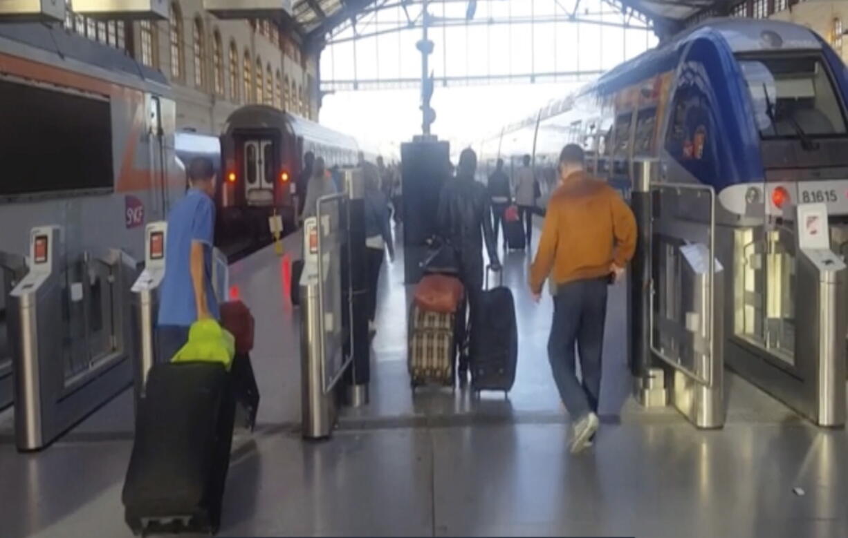 This image taken from video shows passengers inside Marseille-Saint-Charles railway station in Marseille, France on Sunday Sept. 17, 2017. Four young US tourists were attacked with acid Sunday at a train station in the French city of Marseille.