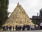 Visitors surround a sandcastle at the Landschaftspark in Duisburg, Germany, on Friday. Artists attempt to secure a spot in the coveted Guinness Book of World Records by building the tallest sandcastle ever.