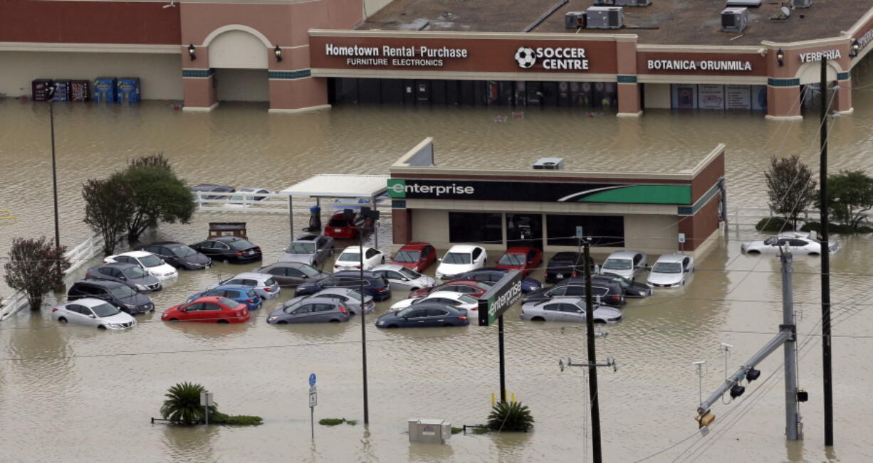 Cars are flooded near the Addicks Reservoir as floodwaters from Tropical Storm Harvey rise in Houston. Tens of thousands of personal vehicles were inundated by floodwaters or smashed by wind-tossed objects, creating a huge demand for rentals that has put the cars in painfully short supply in the Houston area and across eastern Texas. Rental companies say they are bringing in more vehicles from areas including the Southeast, but the logistics problems left by Harvey could get worse as Hurricane Irma threatens Florida. (AP Photo/David J.