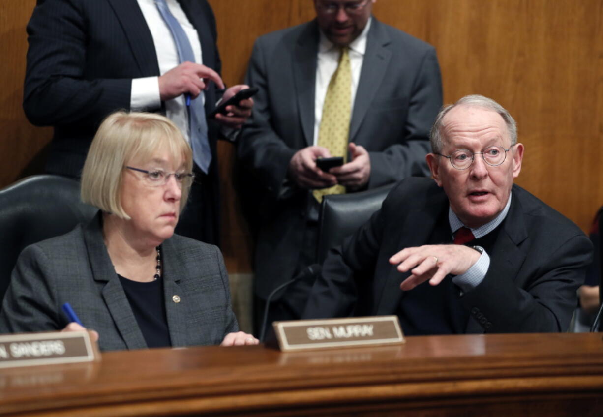 Senate Health, Education, Labor, and Pensions Committee Chairman Sen. Lamar Alexander, R-Tenn., accompanied by the committee’s ranking member Sen. Patty Murray, D-Wash., speaks Jan. 31 on Capitol Hill in Washington. Millions of people who buy individual health insurance policies and get no government help for premiums are facing another year of double-digit premium increases and frustration is boiling over.