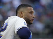 Seattle Mariners' Robinson Cano watches from the dugout during a baseball game against the Cleveland Indians, Sunday, Sept. 24, 2017, in Seattle. The game was the final home game of the season for the Mariners. (AP Photo/Ted S.