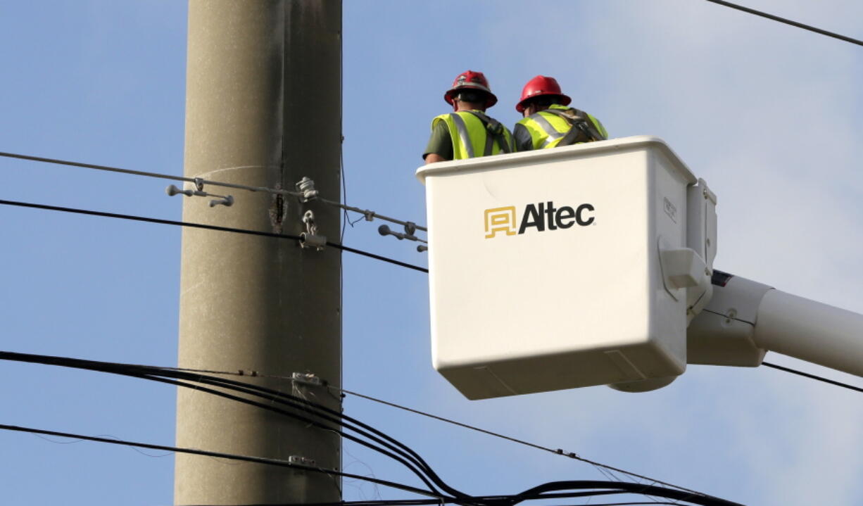 Utility workers check the cables as they work Sept. 14 to reestablish power in the aftermath of Hurricane Irma in Key West, Fla.