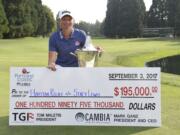 Stacy Lewis poses with the trophy and a check after winning the the Cambia Portland Classic golf tournament in Portland, Ore. on Sunday, Sept. 3, 2017. Lewis is donating her winnings to the Houston Relief to help the victims of Hurricane Harvey.