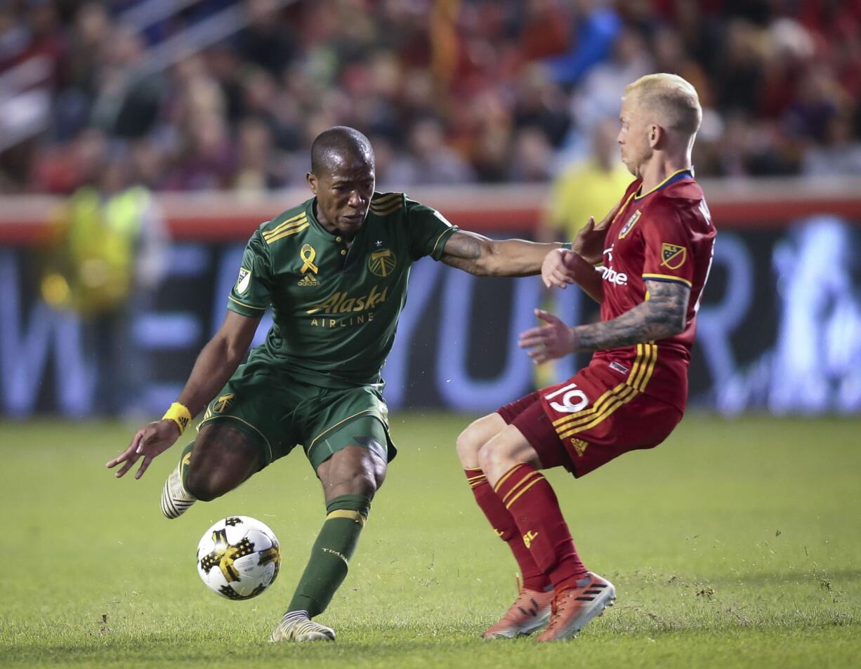 Portland Timbers midfielder Darlington Nagbe (6) fights past Real Salt Lake midfielder Luke Mulholland (19) during an MLS soccer match in Sandy, Utah, Saturday, Sept. 16, 2017.