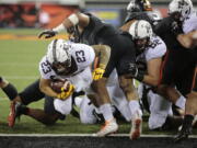 Minnesota’s Shannon Brooks (23) fights his way through the Oregon State defensive line for a touchdown during the first half of an NCAA college football game in Corvallis, Ore., Saturday, Sept. 9, 2017. (AP Photo/Timothy J.