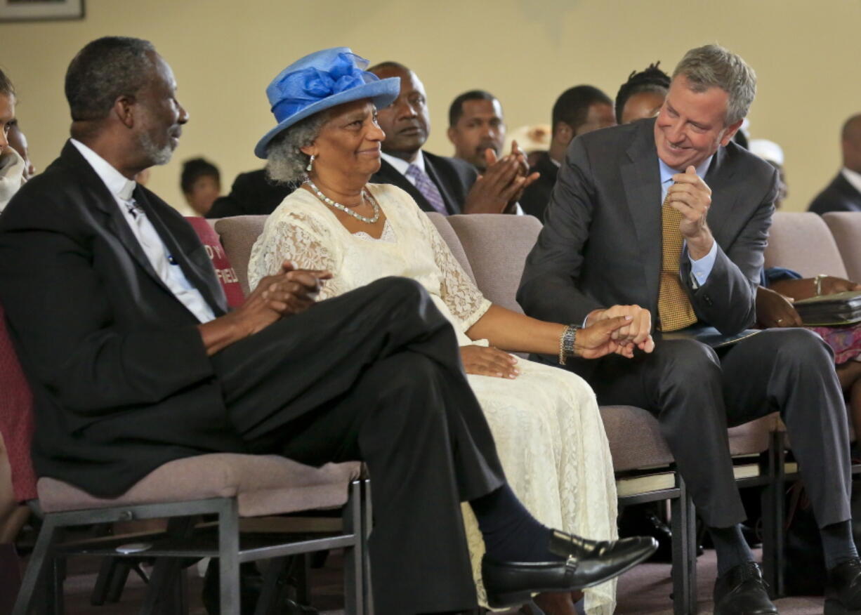 New York City Mayor Bill de Blasio, right, talks with senior pastor Dr. Alfred Cockfield, left, and his wife Linette Cockfield, center, during his visit to their church, God’s Battalion of Prayer Church, in New York. The city’s minority population holds the key to de Blasio’s re-election test.