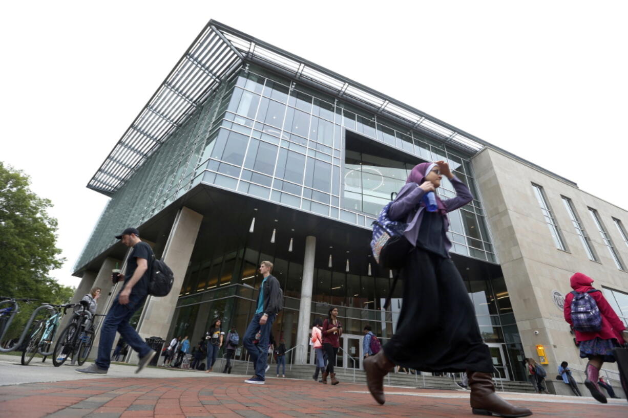 Students walk by the James Branch Cabell Library on the campus of Virginia Commonwealth University in Richmond, Va. Completing the Free Application for Federal Student Aid, or FAFSA is important for college-bound high school seniors but also returning college students.