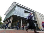 Students walk by the James Branch Cabell Library on the campus of Virginia Commonwealth University in Richmond, Va. Completing the Free Application for Federal Student Aid, or FAFSA is important for college-bound high school seniors but also returning college students.