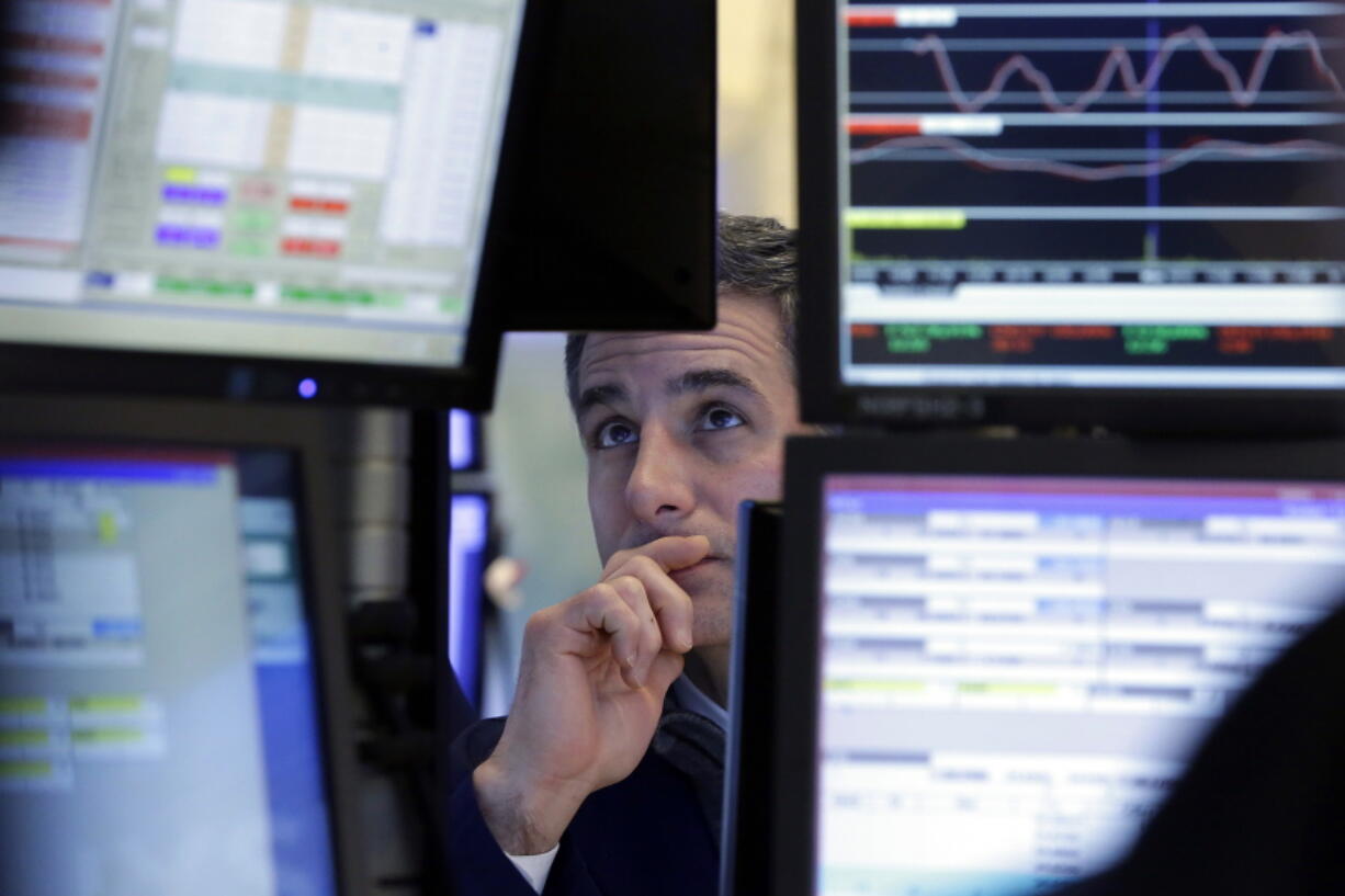 FILE - In this Tuesday, Jan. 24, 2017, file photo, specialist Anthony Rinaldi works at his post on the floor of the New York Stock Exchange. On Thursday, Sept. 21, 2017, the Federal Reserve reports on household wealth for the April-June quarter.