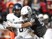 Washington State defensive lineman Hercules Mata’afa (50) sacks Nevada quarterback Kaymen Cureton during the first half of an NCAA college football game in Pullman, Wash., Saturday, Sept. 23, 2017.