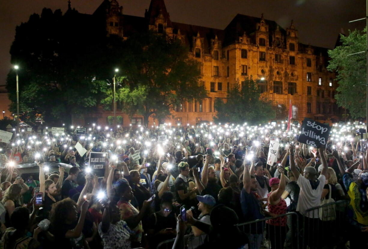 Hundreds of protesters stand outside of the St. Louis city jail on Monday. The protesters chanted “free our people” outside the jail on Monday night to show solidarity with those who remain behind bars. Police said that more than 120 people were arrested during Sunday’s protests. Monday was the fourth day of protests over the acquittal of a white former police officer in the killing of a black suspect. (David Carson/St.