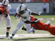 Portland State’s Za’Quan Summers (22) sheds the tackle attempt by Oregon State’s Andrzej Hughes-Murray (49) in the first half of an NCAA college football game, in Corvallis, Ore., Saturday, Sept. 2, 2017. (AP Photo/Timothy J.