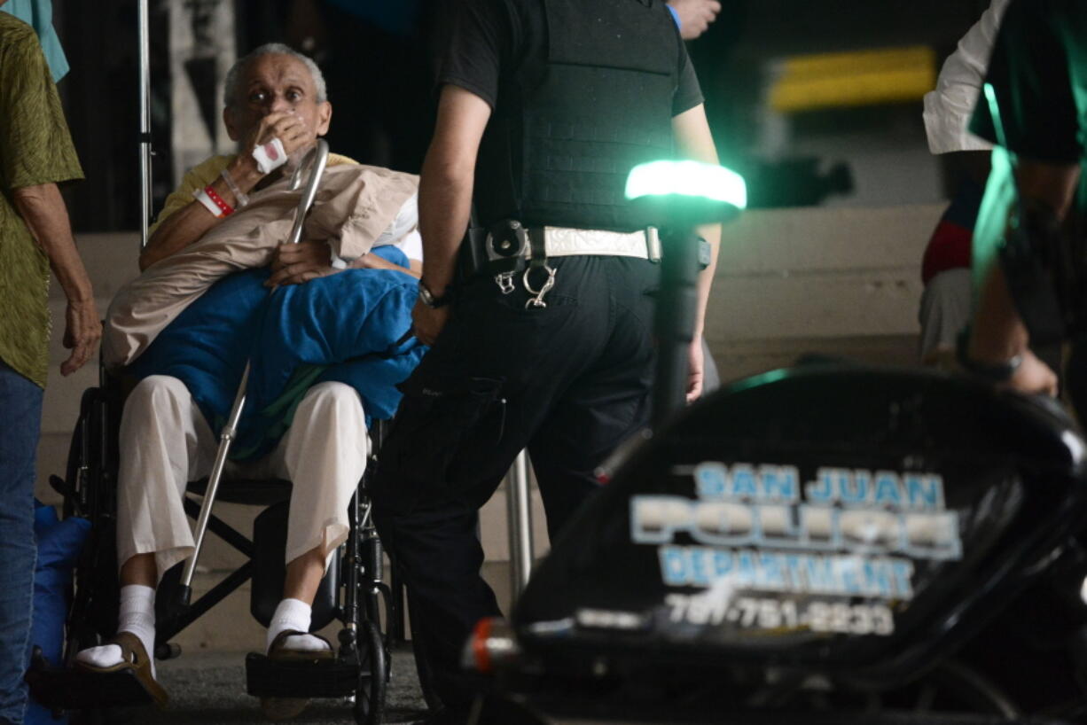 A patient waits to be evacuated Saturday from the San Francisco Hospital in San Juan, Puerto Rico, after an electrical failure.