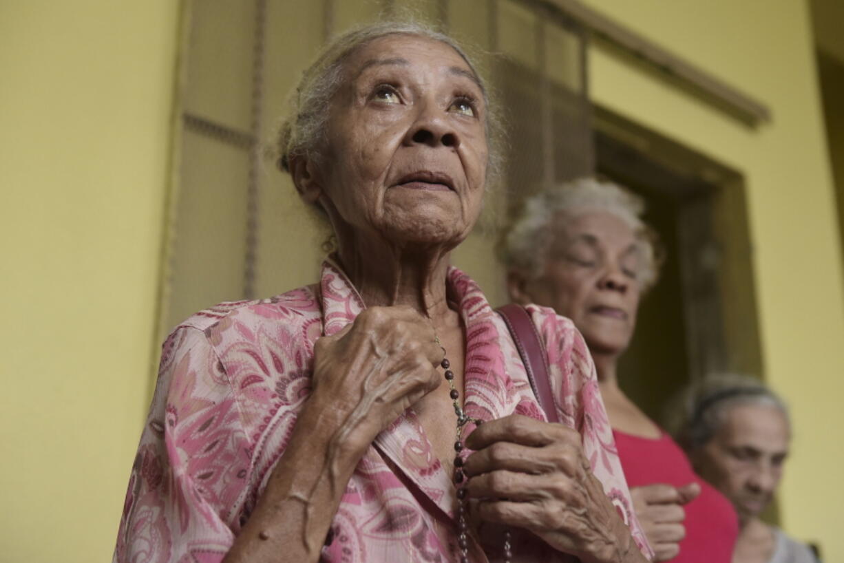 A woman seeking shelter prays her rosary at the Juan Ponce de Leon Elementary School before the arrival of Hurricane Maria, in Humacao, Puerto Rico, Tuesday, Sept. 19, 2017. Puerto Rico is likely to take a direct hit by the category 5 hurricane. Authorities warned people who live in wooden or flimsy homes should find safe shelter before the storm’s expected arrival on Wednesday.