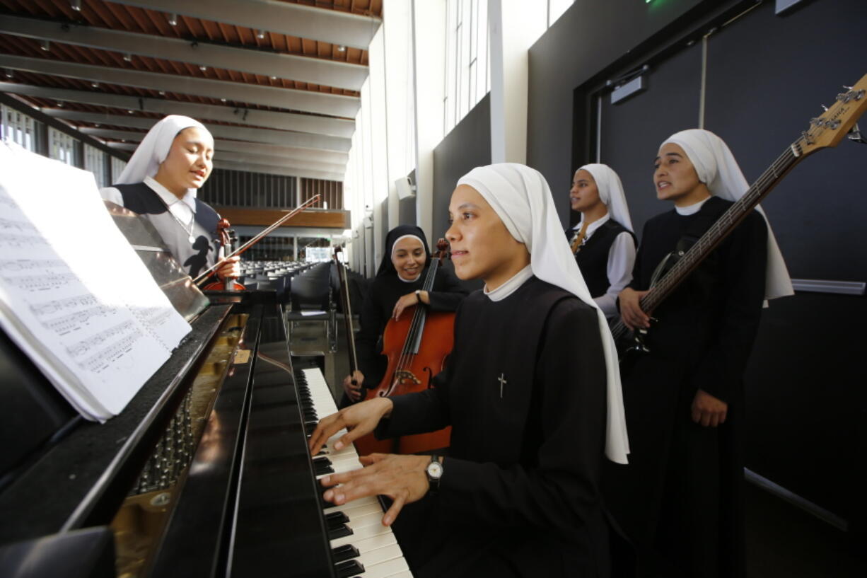 In this Sept. 7, photo members of “Siervas,” a Peruvian-based rock ‘n’ roll band comprised entirely of Catholic nuns rehearse a day ahead of their performance at performance at the Christ Cathedral campus in Garden Grove, Calif. The sisters insist they aren’t rock stars though they’re being considered for a nomination for a Latin Grammy and their concerts draw thousands.