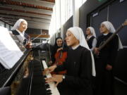 In this Sept. 7, photo members of “Siervas,” a Peruvian-based rock ‘n’ roll band comprised entirely of Catholic nuns rehearse a day ahead of their performance at performance at the Christ Cathedral campus in Garden Grove, Calif. The sisters insist they aren’t rock stars though they’re being considered for a nomination for a Latin Grammy and their concerts draw thousands.