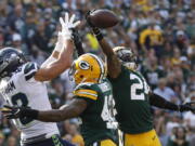 Green Bay Packers’ Quinten Rollins (24) breaks up a pass intended for Seattle Seahawks’ Jimmy Graham during the first half of an NFL football game Sunday, Sept. 10, 2017, in Green Bay, Wis.