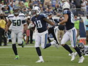 Tennessee Titans wide receiver Rishard Matthews (18) scores a touchdown on a 55-yard pass ahead of Seattle Seahawks outside linebacker K.J. Wright (50) in the second half of an NFL football game Sunday, Sept. 24, 2017, in Nashville, Tenn.