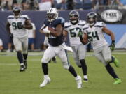 Tennessee Titans running back DeMarco Murray leaves Seattle Seahawks defenders behind as he scores a touchdown on a 75-yard run in the second half of an NFL football game Sunday, Sept. 24, 2017, in Nashville, Tenn.