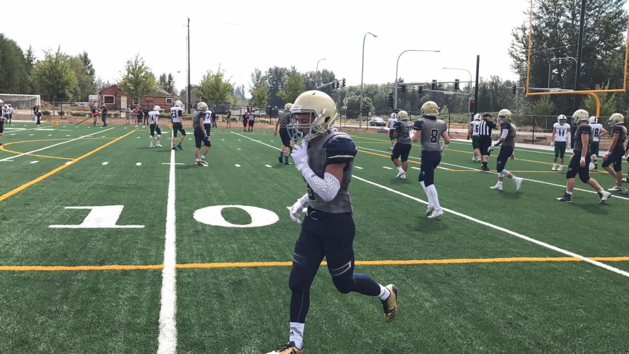 Seton Catholic's Taj Muhammad runs to the sideline after scoring his second of two touchdowns — an 11-yard run — on the day in Saturday's 22-13 loss to to Charles Wright Academy. The game was the Cougars' first on their new home field.