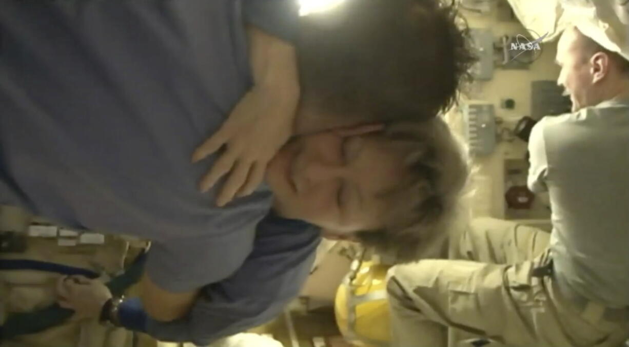 In this image from video made available by NASA, departing astronaut Peggy Whitson hugs Paolo Nespoli aboard the International Space Station during preparations for a return to Earth by her, Jack Fischer and cosmonaut Fyodor Yurchikhin on Saturday, Sept. 2, 2017.