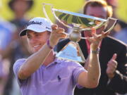 Justin Thomas holds the trophy after winning the Fedex Cup after the Tour Championship golf tournament at East Lake Golf Club in Atlanta, Sunday, Sept. 24, 2017, in Atlanta.