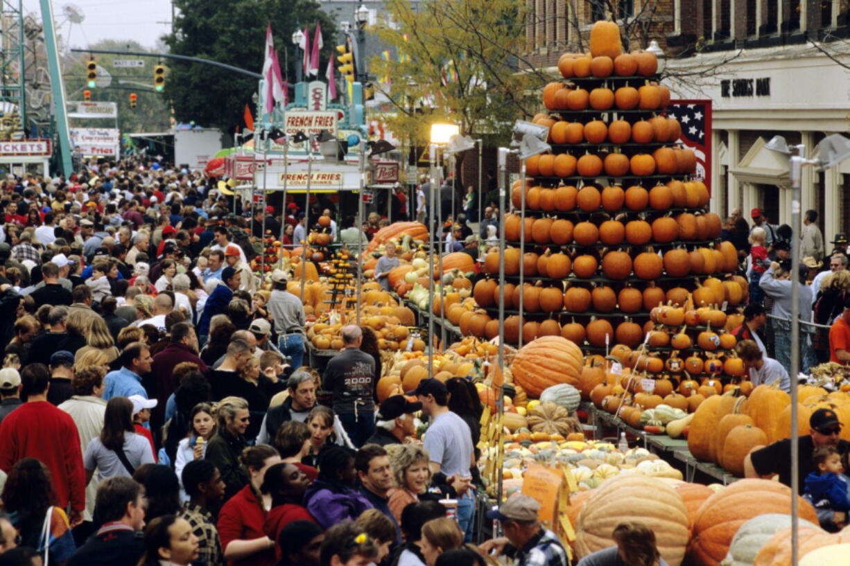 A display of pumpkins shaped like a tree amid crowds at the Circleville Pumpkin Show in Circleville, Ohio. The small town of just 12,000 people south of Columbus attracts tens of thousands of visitors to its free pumpkin festival each October, this year scheduled for Oct. 18-21.