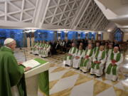 Pope Francis holds up the holy host as he celebrates Mass at the Santa Marta residence at the Vatican, Tuesday, Sept. 19, 2017.