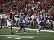 Washington wide receiver Dante Pettis (8) runs a punt-return for a touchdown as as Andre Baccellia (5) blocks Rutgers punter Ryan Anderson during the first half of an NCAA college football game Friday, Sept. 1, 2017, in Piscataway, N.J.