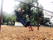 DeWayne Ledbetter of Portland and Lee Rafferty of Vancouver swing at Esther Short Park in downtown Vancouver with the Parks Foundation for Give More 24! on Thursday morning.