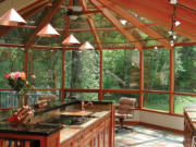 An outdoor kitchen protected from the elements. Sunrooms provide natural light throughout the day.