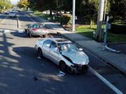 Deputies review the scene after a stolen car, which the sheriff's office said was fleeing police pursuit, hit another car at Northeast 124th Avenue and Northeast 99th Street Tuesday. One person was injured and the fleeing driver was arrested.