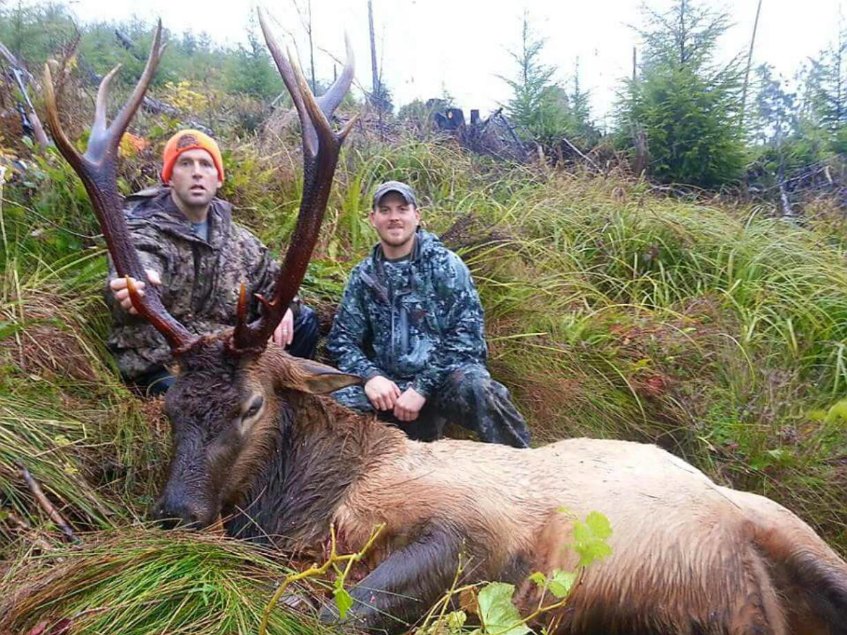 Brian Lewis, (right), of Twisted Horn Outfitters poses with a client and a quality Roosevelt bull elk taken in SW Washington.