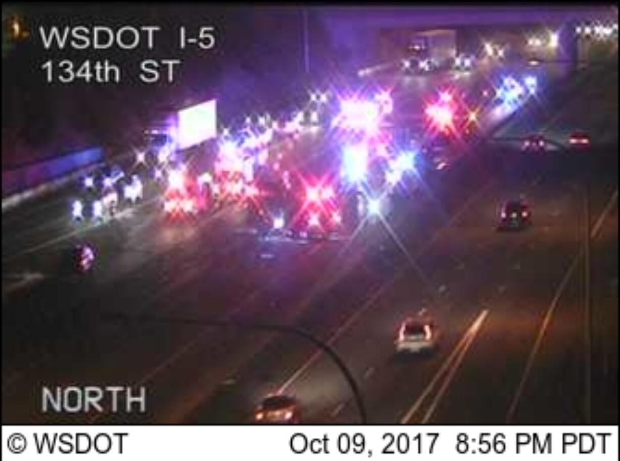 Police and fire personnel, shown here in traffic camera footage, respond after a fatal crash on Interstate 5 in the Salmon Creek area Monday night.