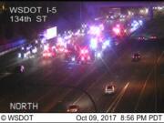 Police and fire personnel, shown here in traffic camera footage, respond after a fatal crash on Interstate 5 in the Salmon Creek area Monday night.