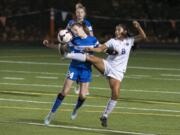 Columbia River's Yaneisy Rodriguez (8), right, fouls Ridgefield's Tegan Petersen (24), left, during the 2A district semifinals at Kiggins Bowl in Vancouver on Tuesday evening Oct. 31, 2017.