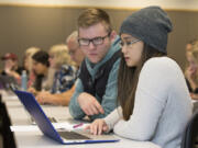 Junior Brayden Cooley, left, and senior Maciel Draculan work on a digital polarization initiative assignment at Washington State University Vancouver.