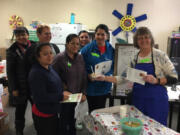 María Mis, from left, Teresa Solórzano, Raquel Vázquez, María Martínez, Carina Smith, Luisa Turner and Marty Fields attend a food tasting hosted by the Washington State University Extension’s Supplemental Nutrition Assistance Program Education in Marrion Elementary School’s Family Community Resource Center.