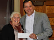 Honorable Frank L. and Arlene G. Price Foundation Executive Director Kay Dalke-Sheadle, left, presents a check for $20,000 to John Vanderkin, Workforce Southwest Washington board chairman, to help fund a Kelso youth workforce training program.