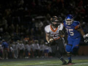 Washougal’s Kade Coons #5 is pursued by Ridgefield’s Makani Shultz at a game in Ridgefield Friday September 29, 2016. Washougal squared off with Ridgefield.